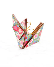 Small wooden origami fox ornament featuring pink and white flowers with green stems on a blue background with metallic gold details.