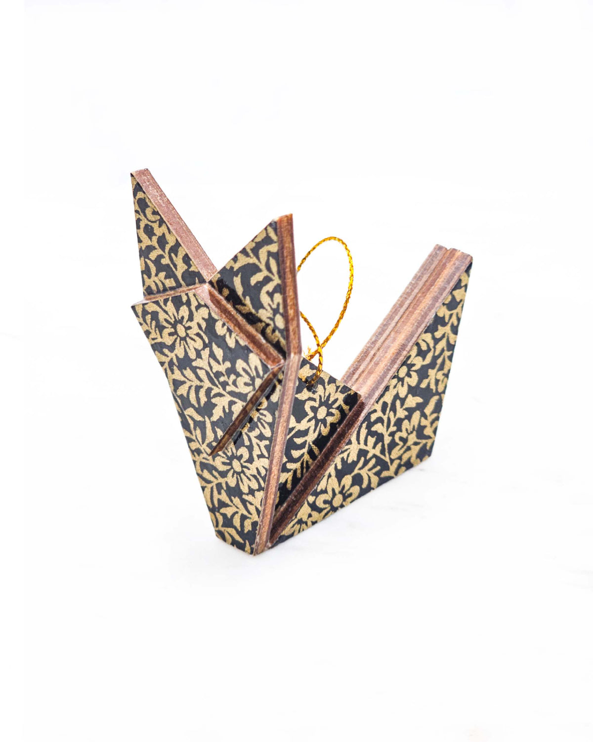 Small wooden origami fox ornament featuring a metallic gold floral motif on a black background.