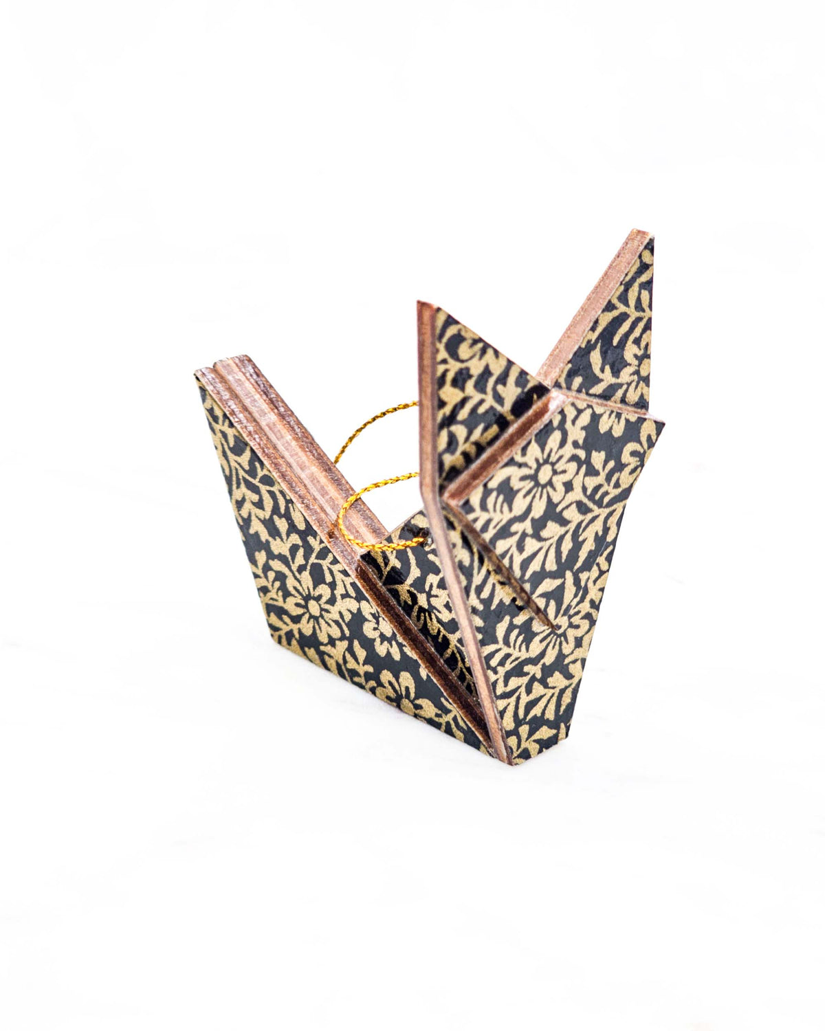 Small wooden origami fox ornament featuring a metallic gold floral motif on a black background.