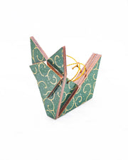 Small wooden origami fox ornament featuring a metallic gold traditional karakusa design on a green background with silver glitter accents.
