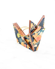 Small wooden origami fox ornament featuring orange, blue, green, and cream plum blossoms on a dark blue background with metallic gold details.
