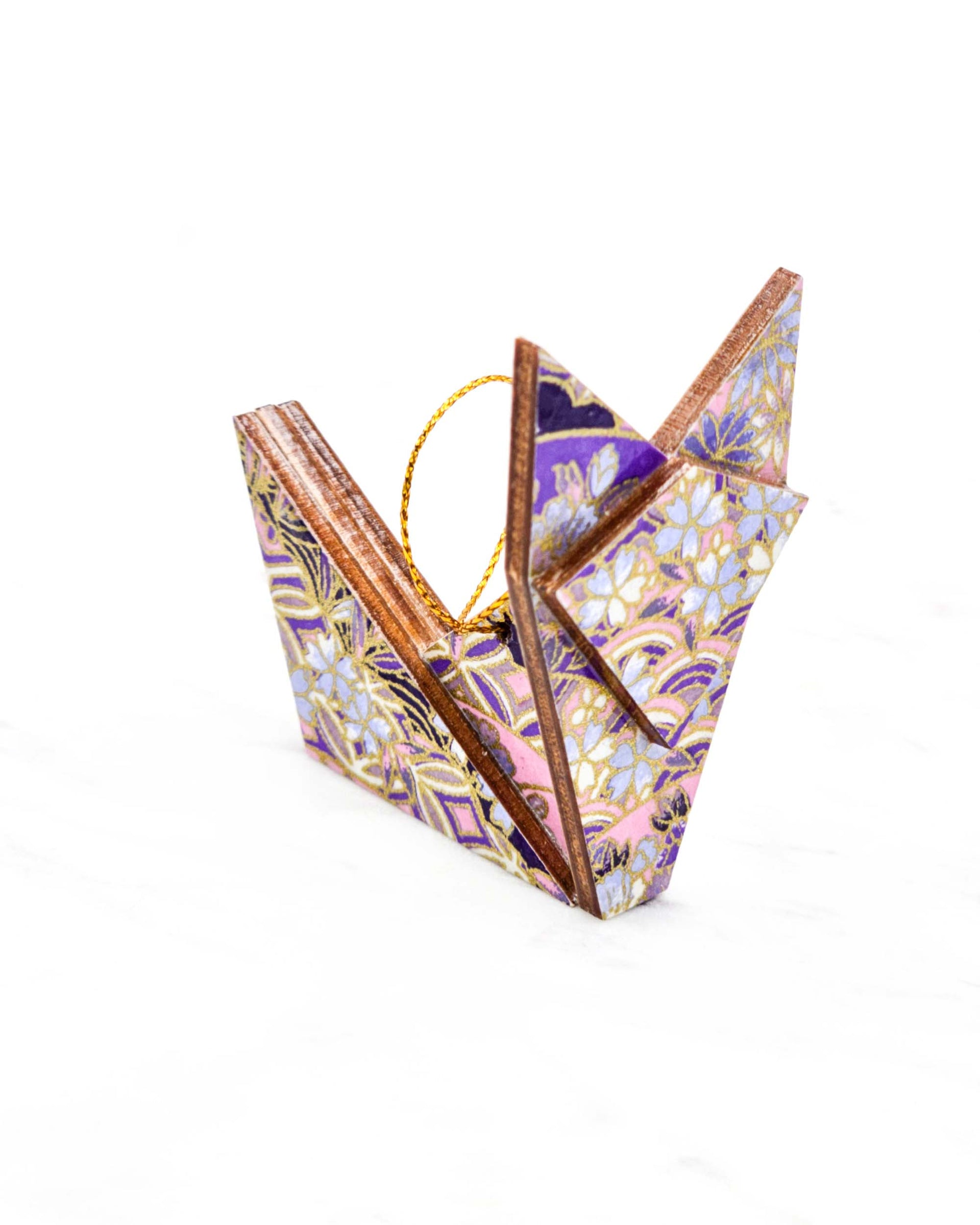 Small wooden origami fox ornament featuring small purple cherry blossoms and purple and white shippo and seigaiha patterns with metallic gold details.
