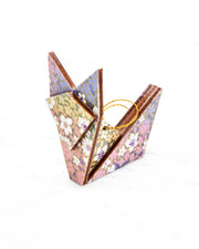 Small wooden origami fox ornament featuring small rainbow-colored flowers with metallic gold details.