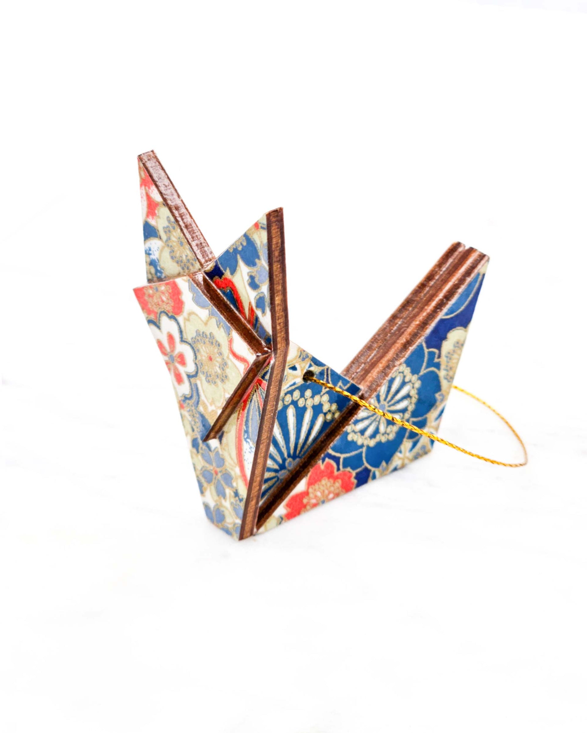 Small wooden origami fox ornament featuring red, white, and blue cherry blossoms with metallic gold details.