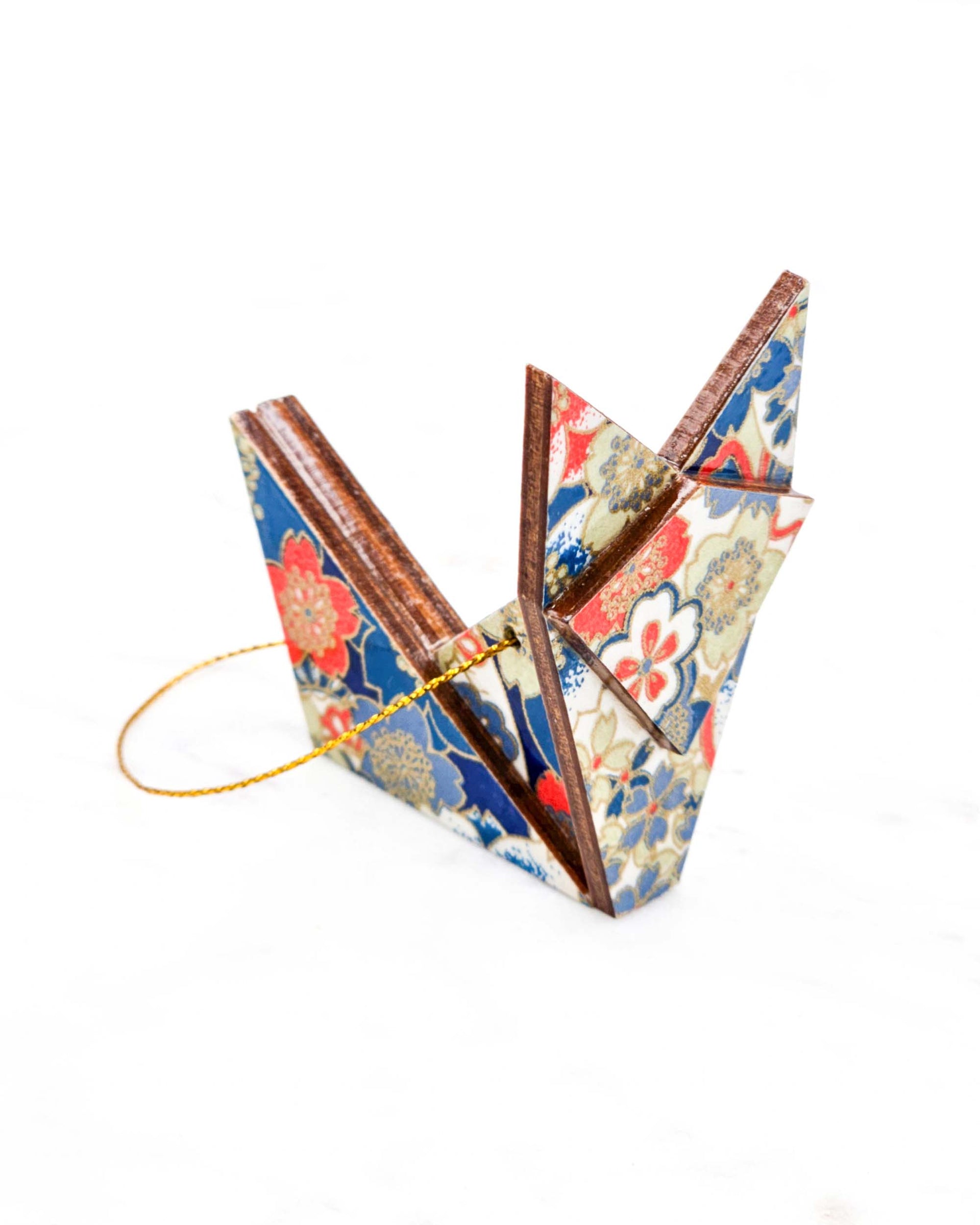 Small wooden origami fox ornament featuring red, white, and blue cherry blossoms with metallic gold details.