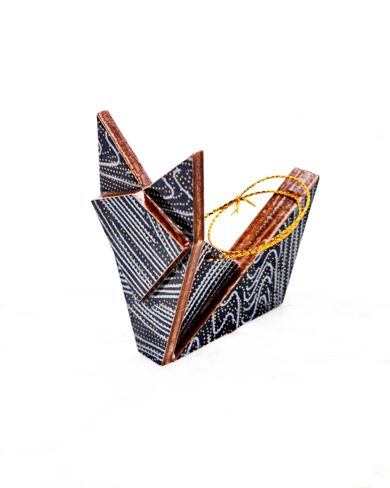 Small wooden origami fox ornament featuring metallic silver and gold ripples on a black background.