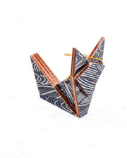 Small wooden origami fox ornament featuring metallic silver and gold ripples on a black background.