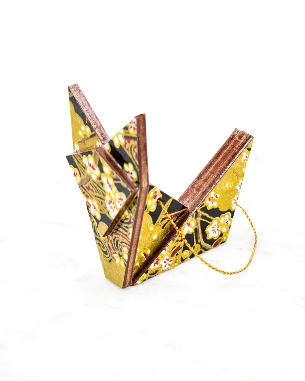 Small wooden origami fox ornament featuring small white plum blossom branches with gold and red water ripples and large gold clouds on a black background with metallic gold details.