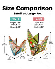 A size comparison display of the small and large wooden origami fox ornaments.