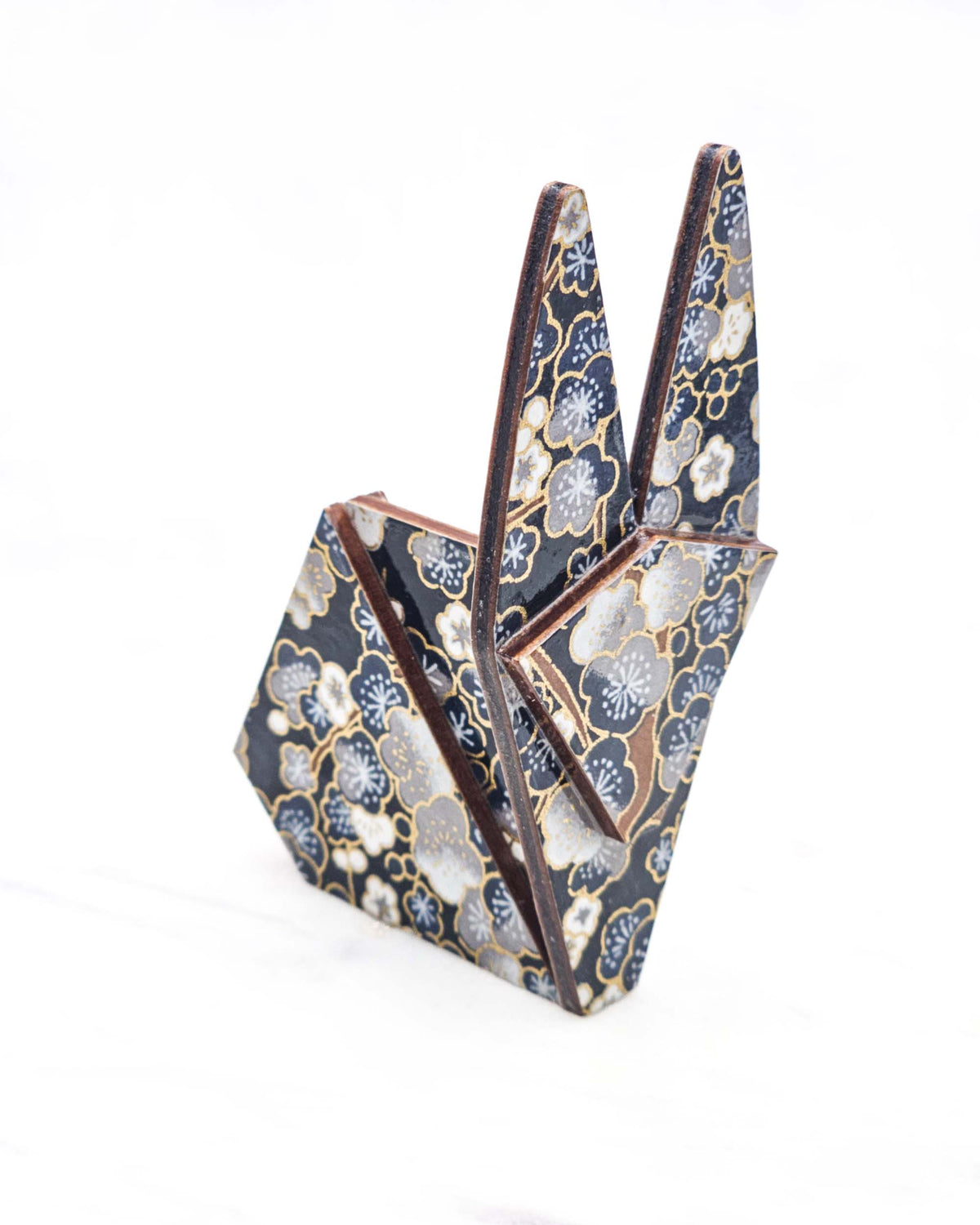 Large wooden origami rabbit ornament featuring blue and gray plum blossoms with brown branches on a dark blue background with metallic gold details