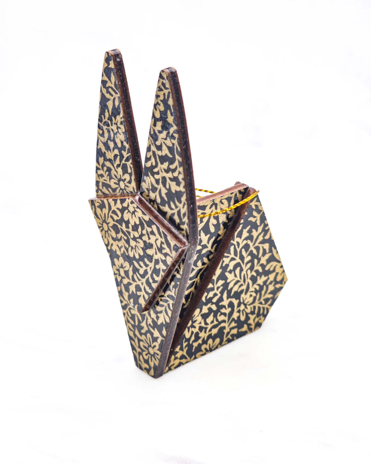 Large wooden origami rabbit ornament featuring a metallic gold floral motif on a black background.