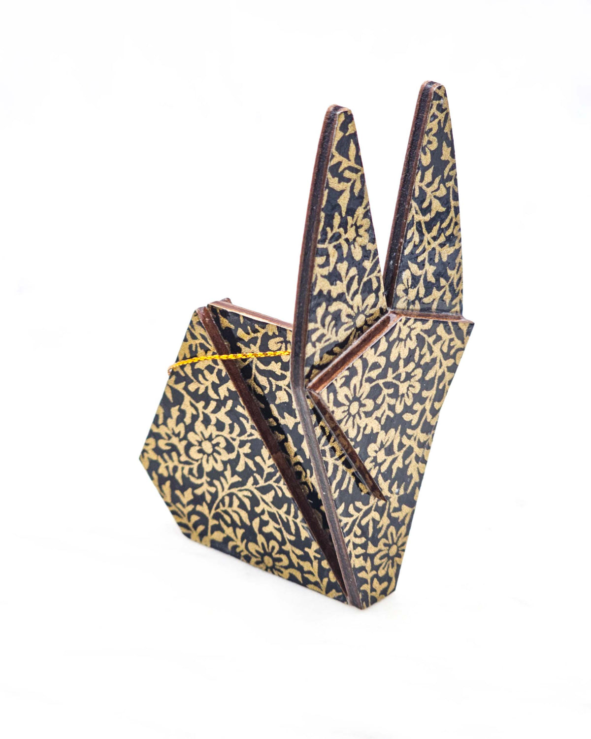 Large wooden origami rabbit ornament featuring a metallic gold floral motif on a black background.