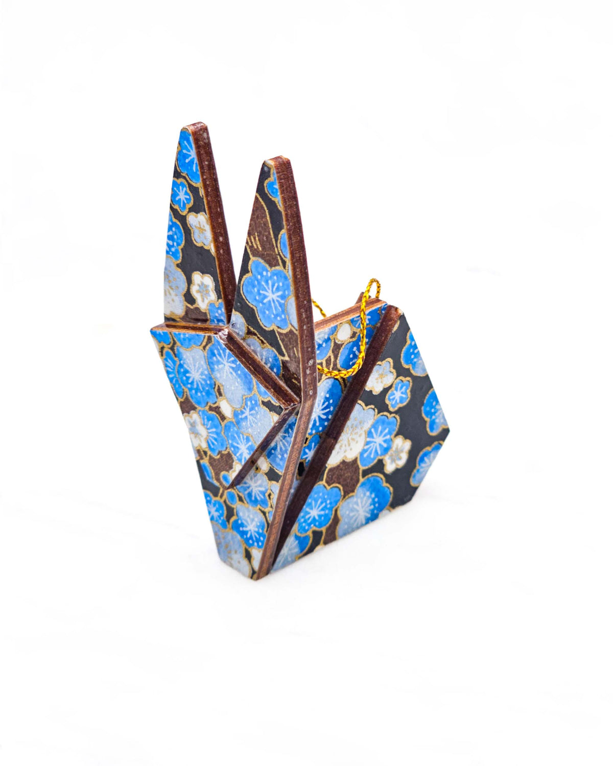 Small wooden origami rabbit ornament featuring blue plum blossoms with brown branches on a black background with metallic gold details.