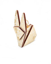 Small wooden origami rabbit ornament featuring small white and metallic gold cherry blossoms on pearlescent cream background with metallic silver details.
