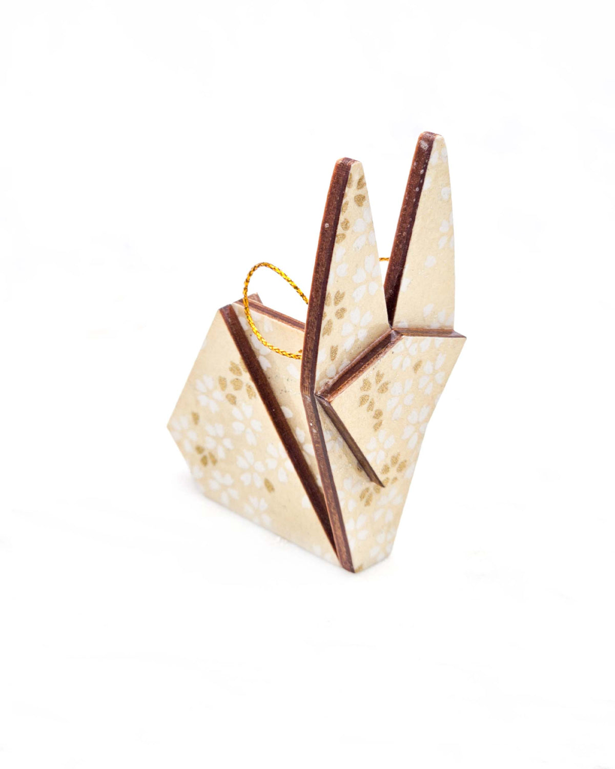 Small wooden origami rabbit ornament featuring small white and metallic gold cherry blossoms on pearlescent cream background with metallic silver details.