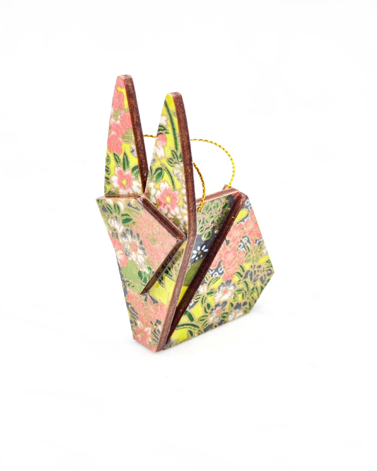 Small wooden origami rabbit ornament featuring small white, green, and orange flowers on a gray and green background with metallic gold details.