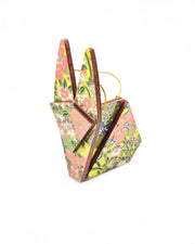 Small wooden origami rabbit ornament featuring small white, green, and orange flowers on a gray and green background with metallic gold details.