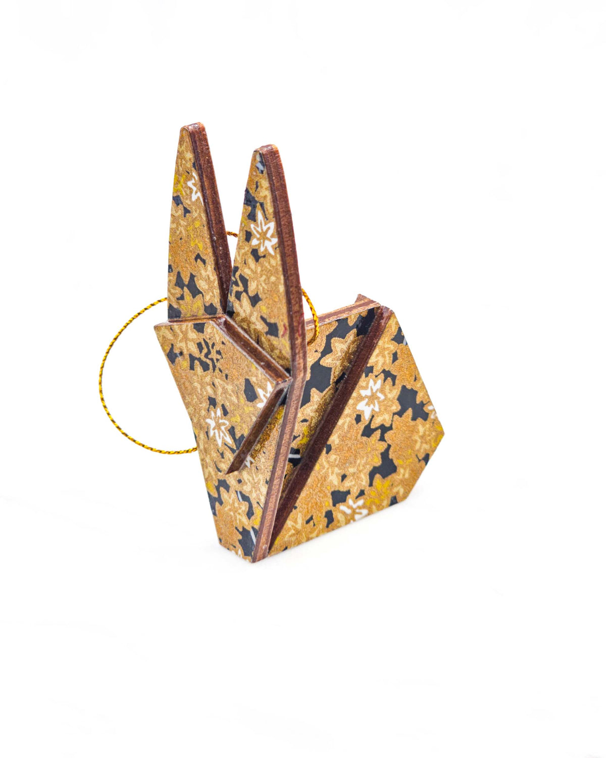 Small wooden origami rabbit ornament featuring small metallic gold and white momiji (maple leaves) on a black background.