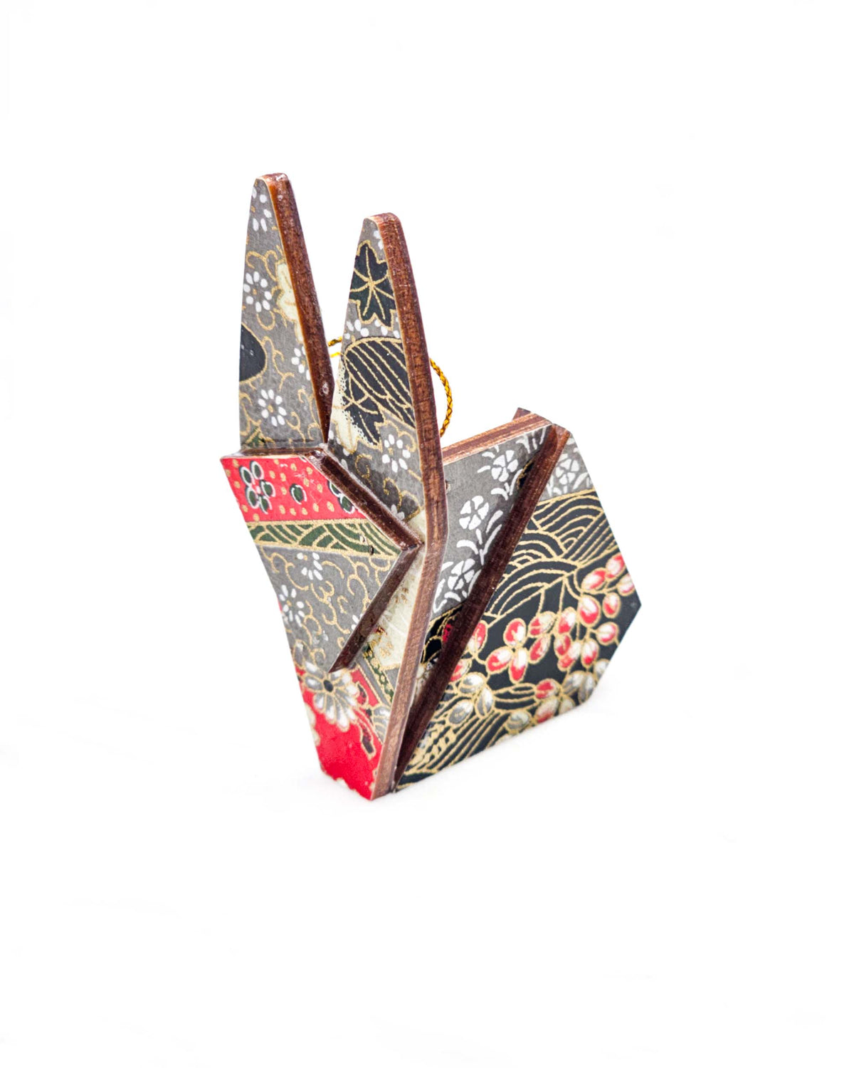 Small wooden origami rabbit ornament featuring red, gray, black, and off white patches with an assortment of various floral patterns and metallic gold details.