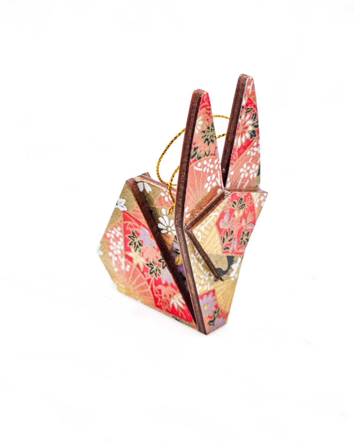 Small wooden origami rabbit ornament featuring red and purple floral hand fans and gold floral ribbons on an orange gradient background covered in small white plum blossoms with metallic gold details.