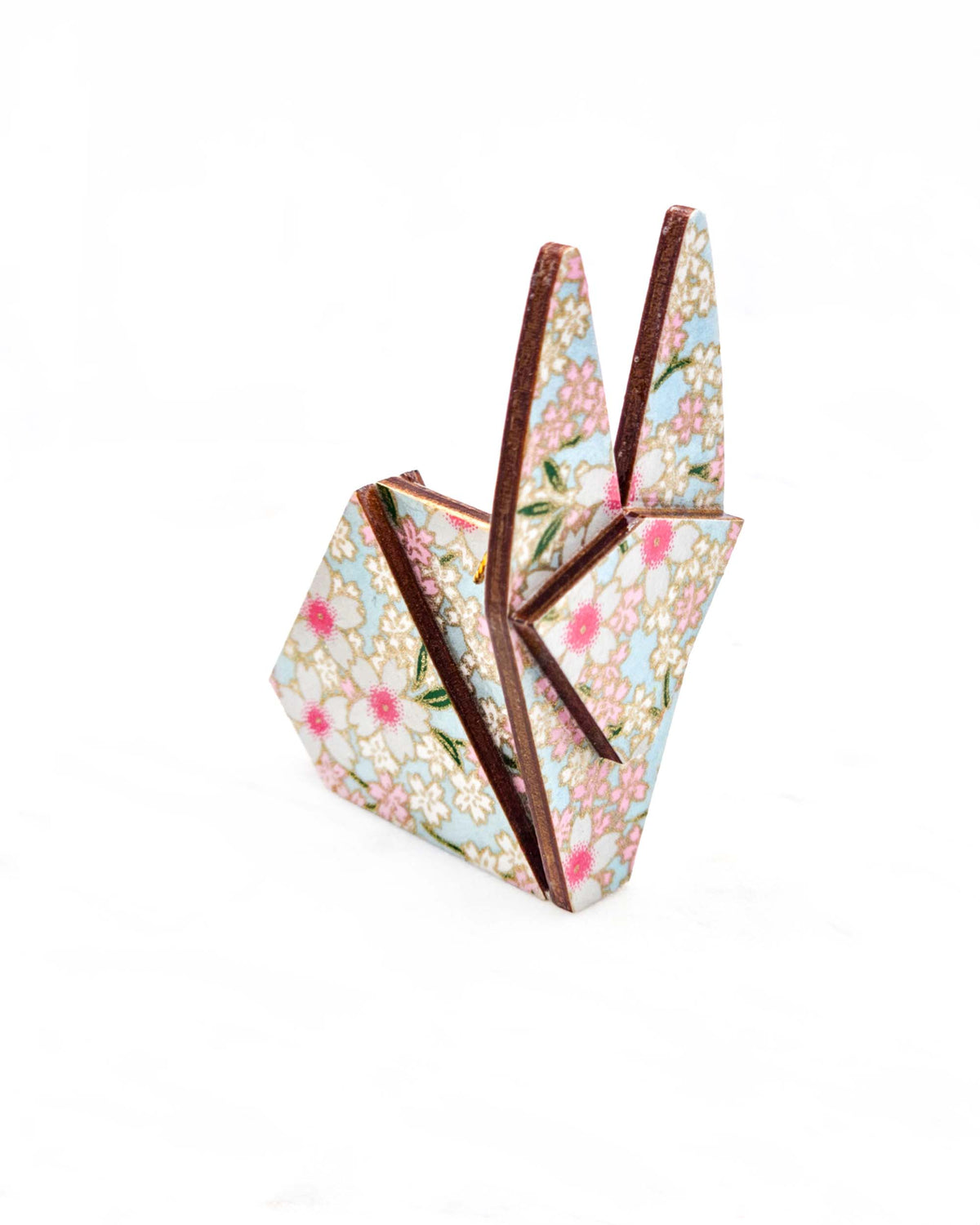 Small wooden origami rabbit ornament featuring white and pink cherry blossoms on a light blue background with metallic gold details.