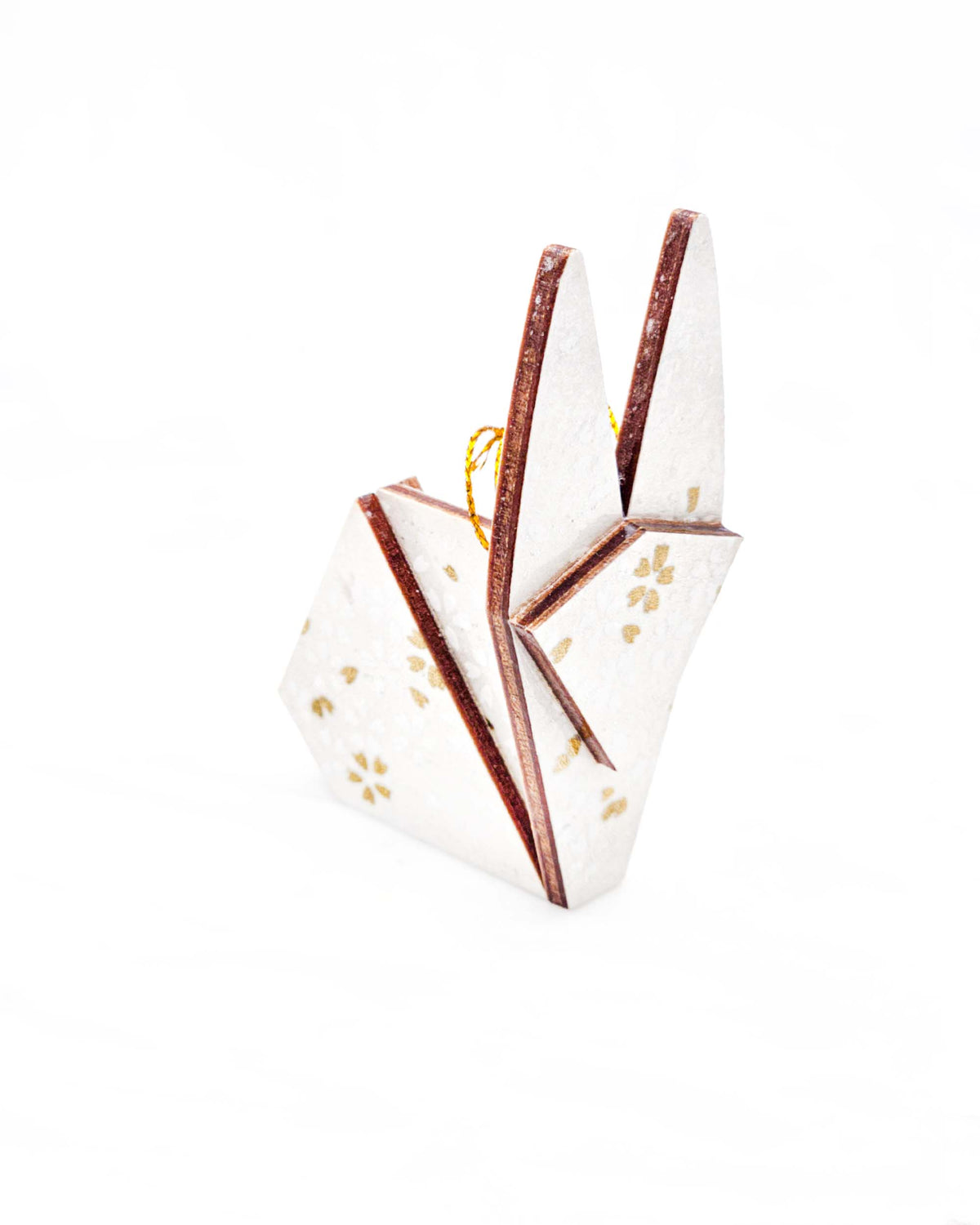 Small wooden origami rabbit ornament featuring gold and white cherry blossoms on a pearlescent white background with small metallic silver specks.