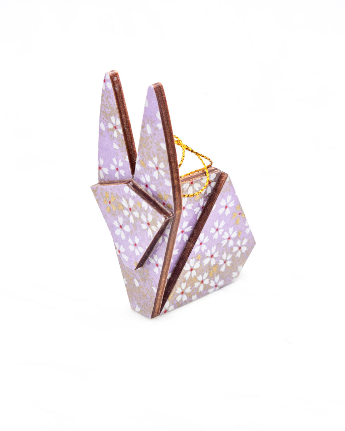 Small wooden origami rabbit ornament featuring small white and gold cherry blossoms on a purple background with metallic gold details.