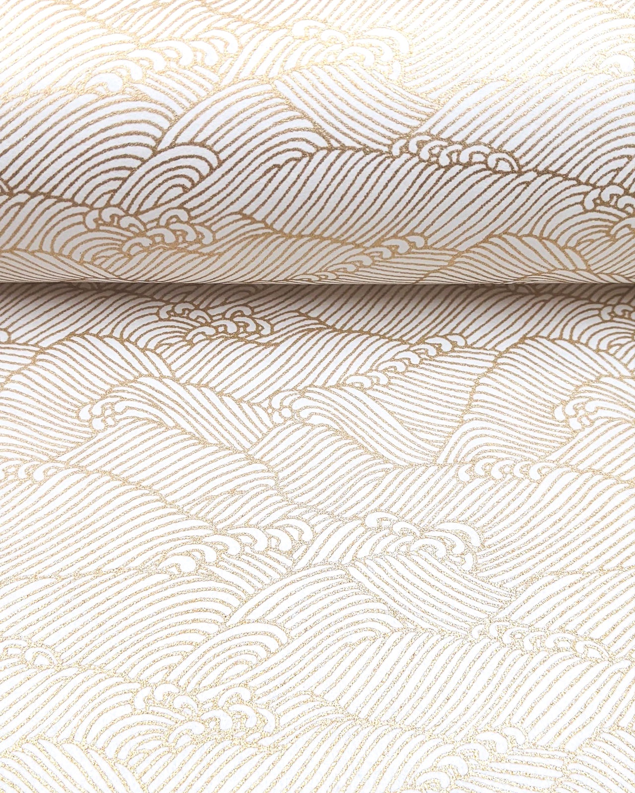 Japanese chiyogami featuring small metallic gold waves on a white background.