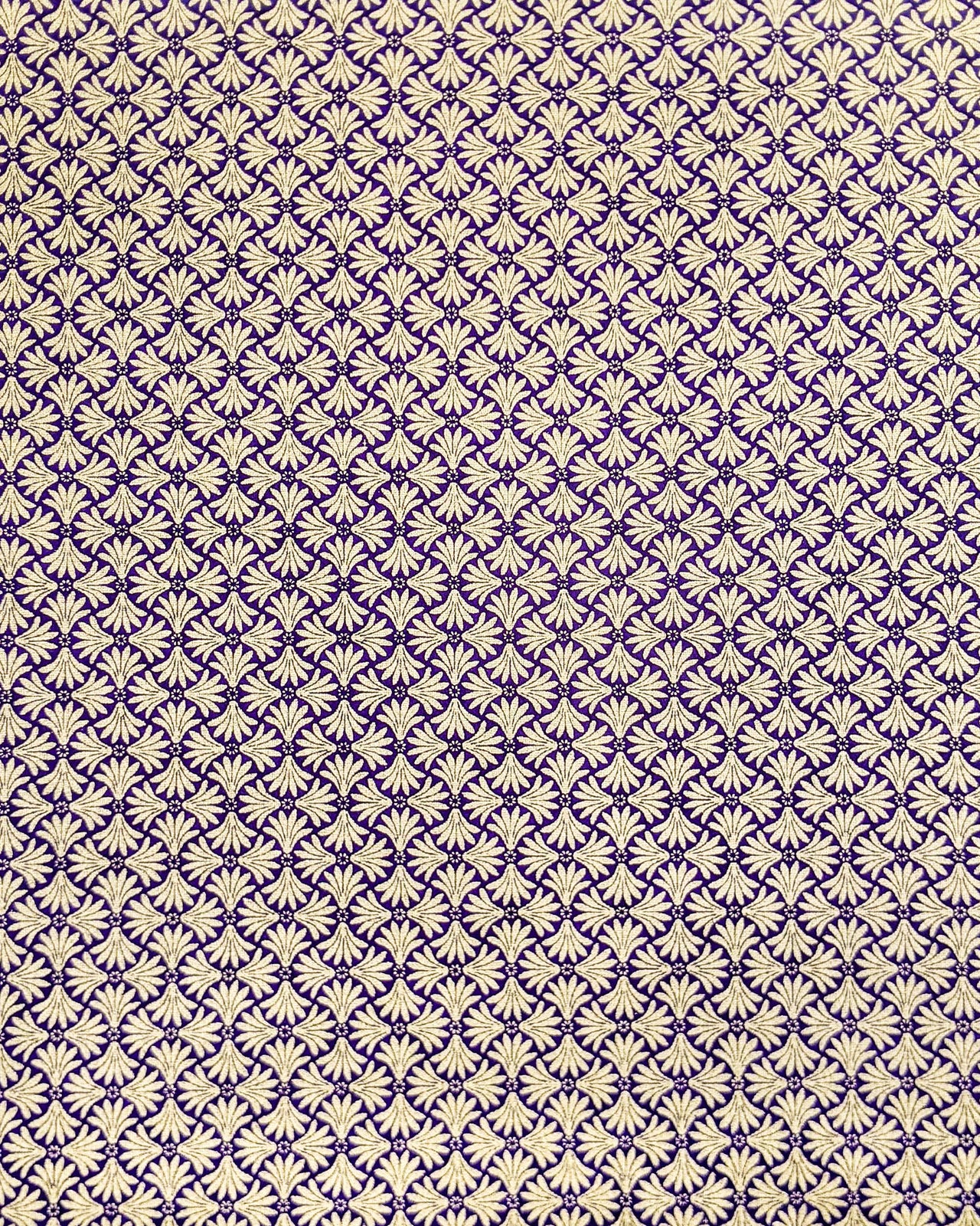 Japanese chiyogami paper featuring a metallic gold geometric pattern on a purple background.