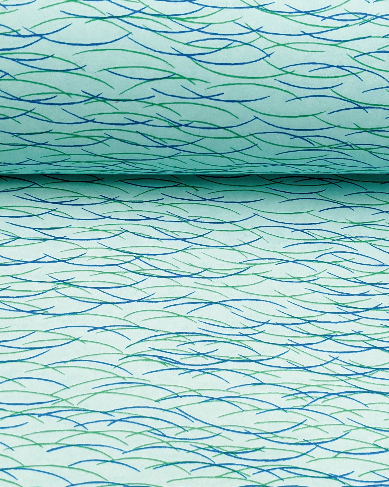Japanese chiyogami paper featuring dark blue & green lines on a turquoise background.