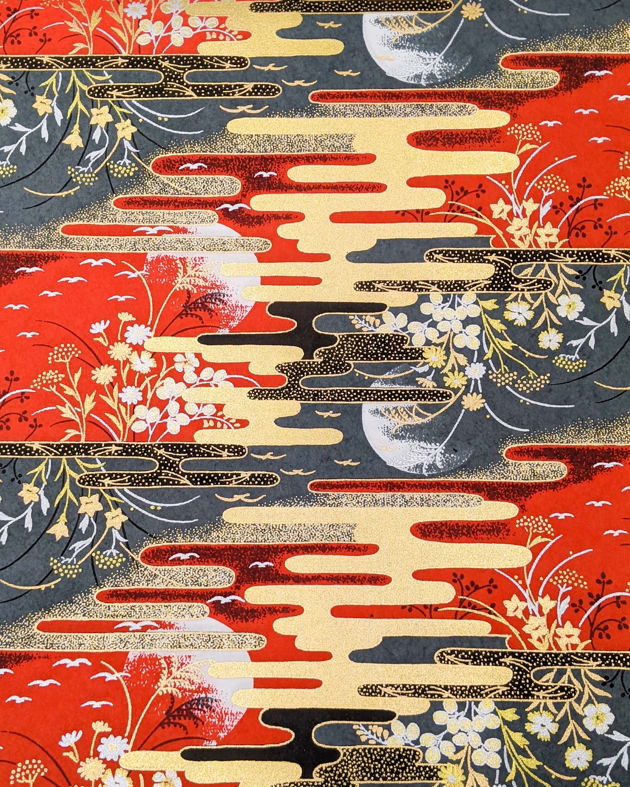 Japanese chiyogami paper featuring full moons, flowers, and flying birds on a red and gray background with metallic silver and gold accents.