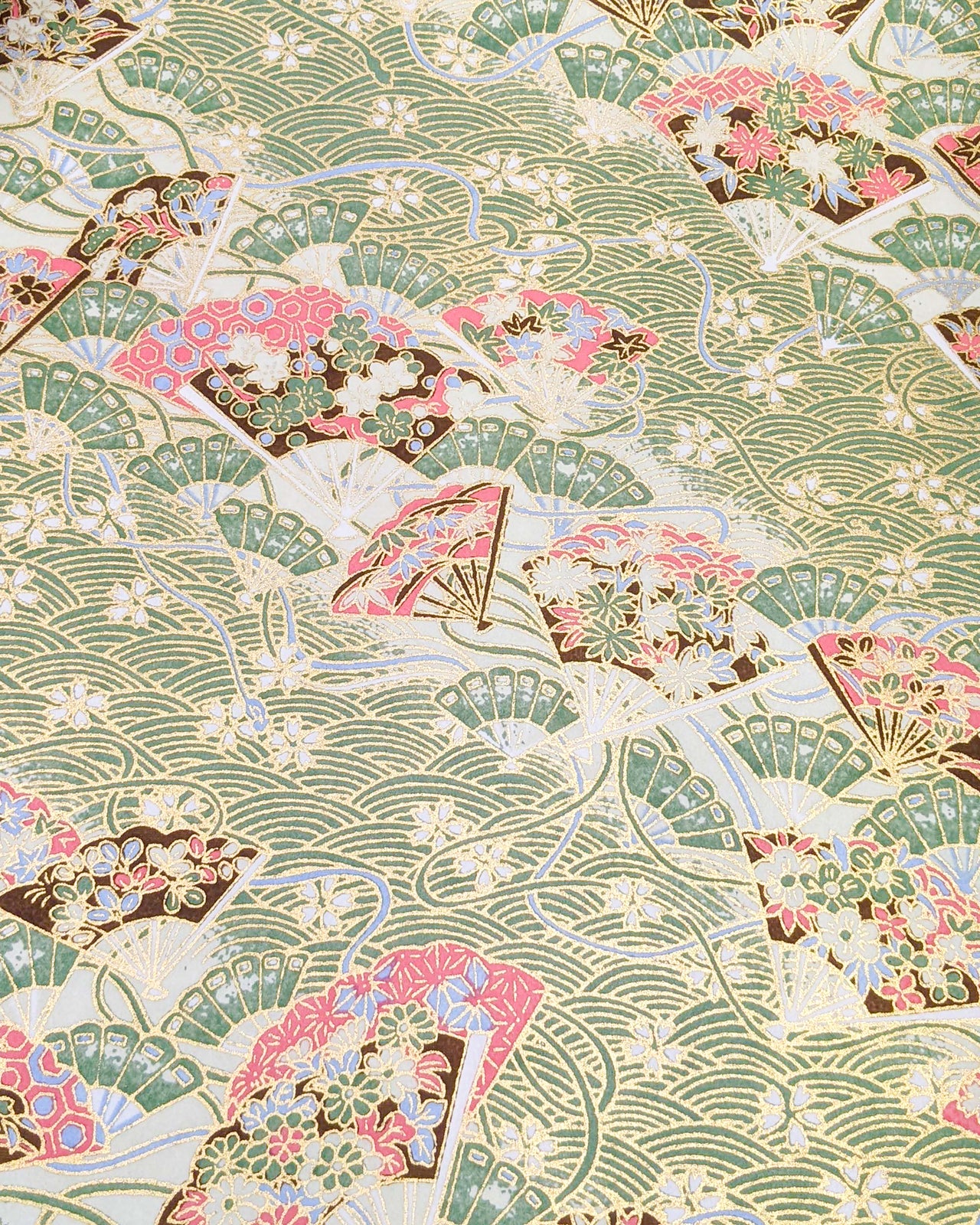 Japanese chiyogami featuring floral hand fans on a green wave crest background with metallic gold accents.