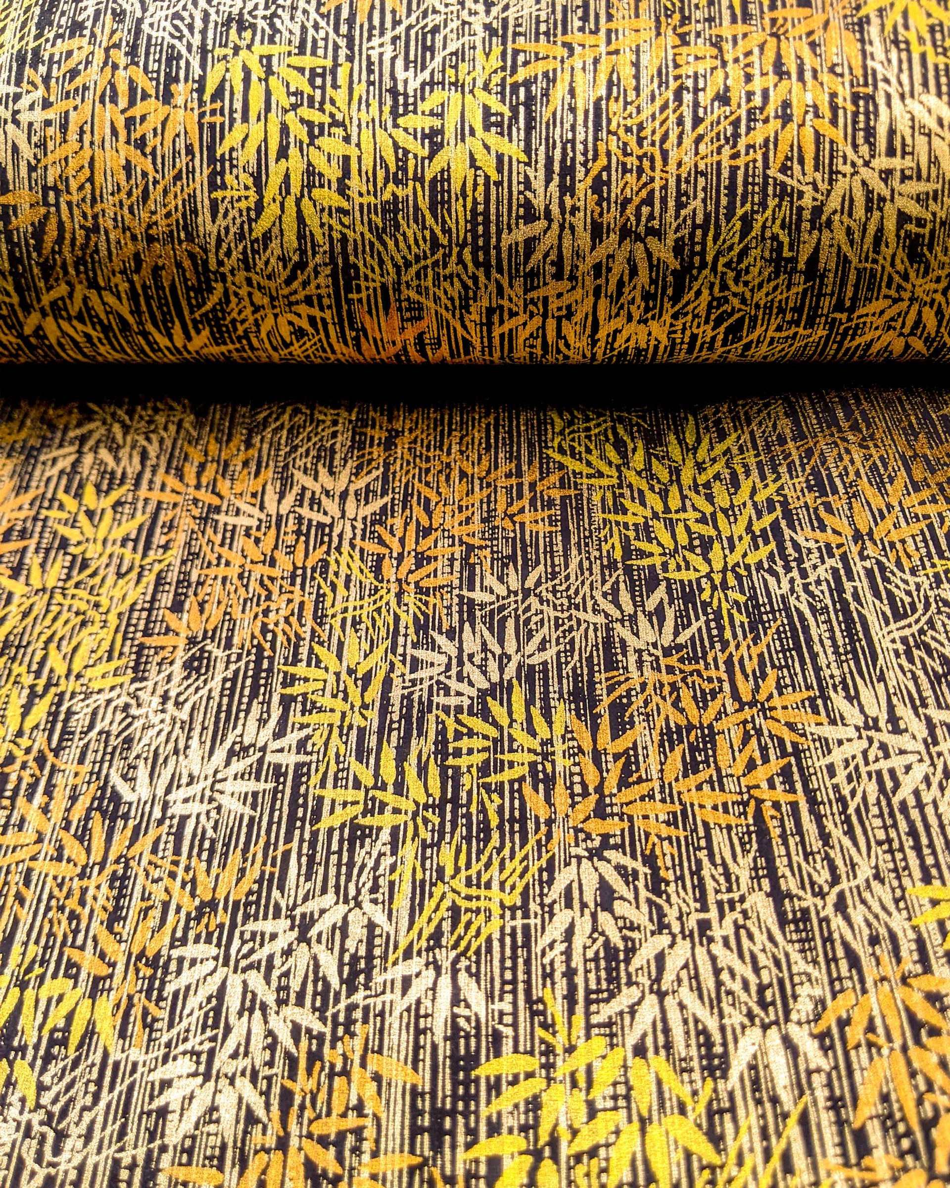 Japanese chiyogami paper featuring metallic gold and copper bamboo shoots on a black background.