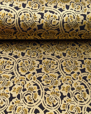 Japanese chiyogami paper featuring a large metallic gold swirl motif on a black background.