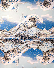 Japanese chiyogami paper featuring a bright blue version of the famous painting "The Great Wave Off Kanagawa" by Katsushika Hokusai with metallic gold details. 