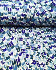 Japanese chiyogami paper featuring blue and white interlocking yagasuri (arrow) swirls with metallic gold details.