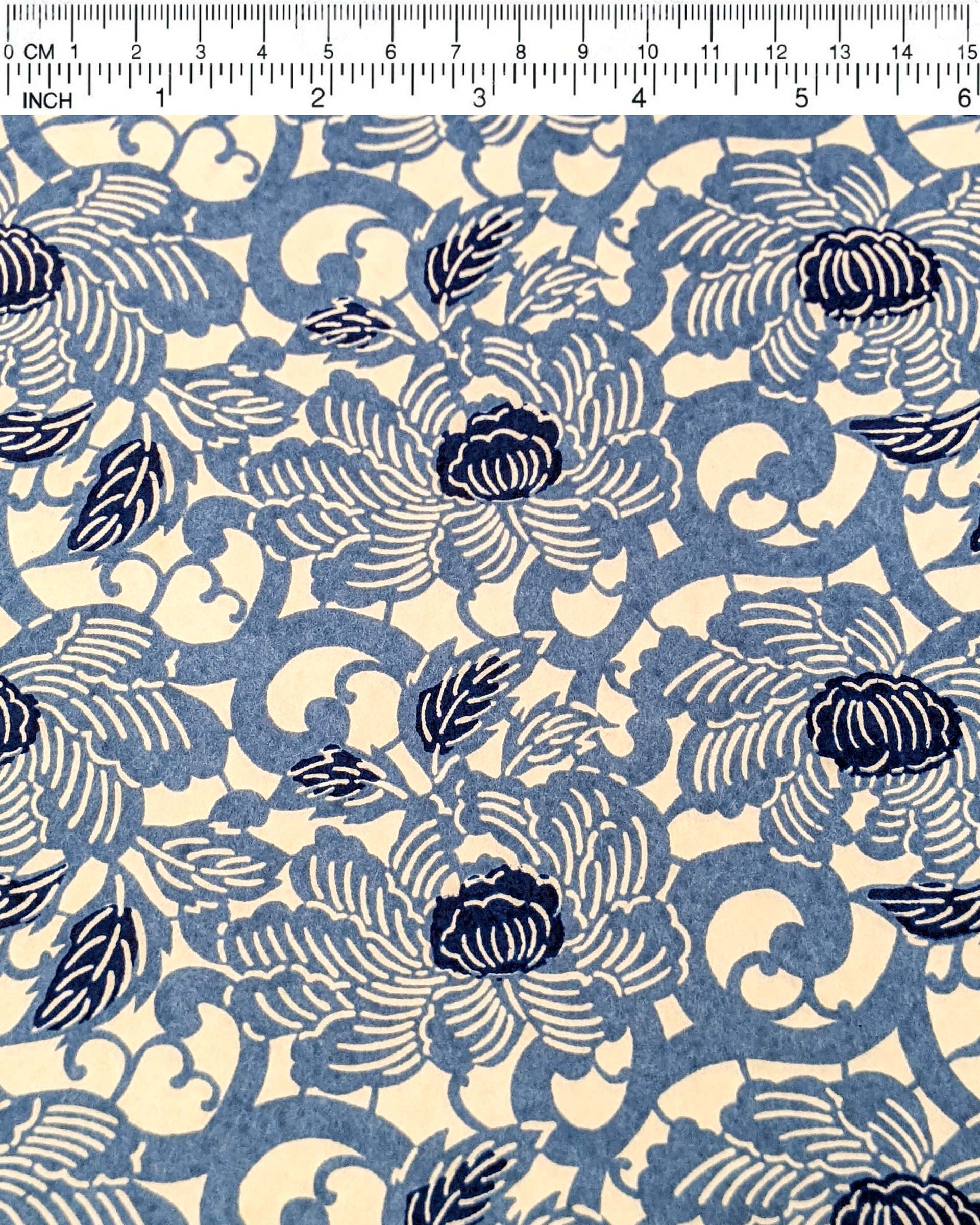 Japanese chiyogami paper featuring large blue peonies on a cream background.