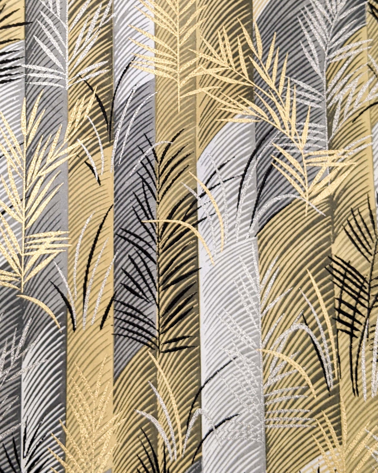 Japanese chiyogami paper featuring metallic gold and silver leaves on a gray and brown background.