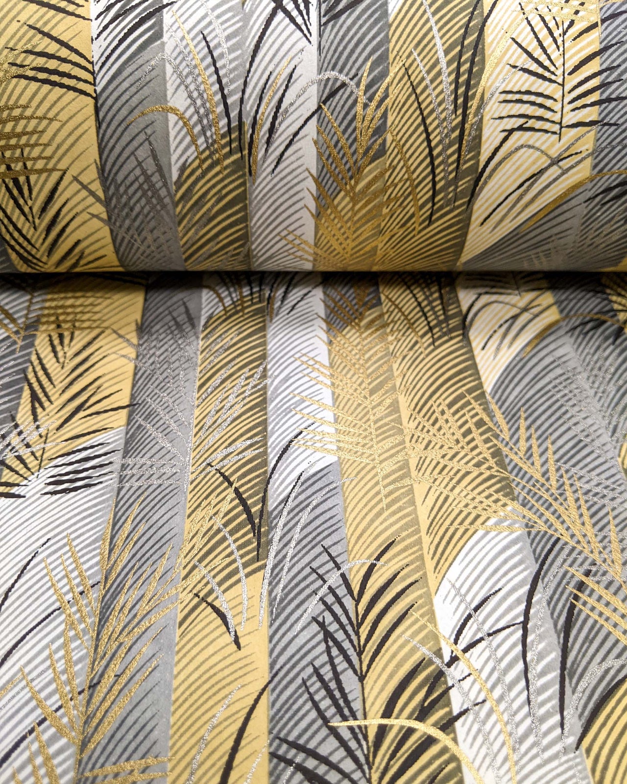 Japanese chiyogami paper featuring metallic gold and silver leaves on a gray and brown background.