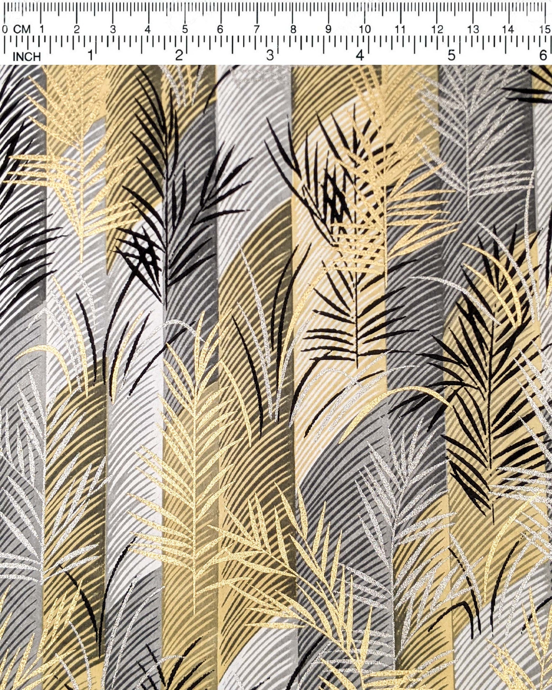 Japanese chiyogami paper featuring metallic gold and silver leaves on a gray and brown background.