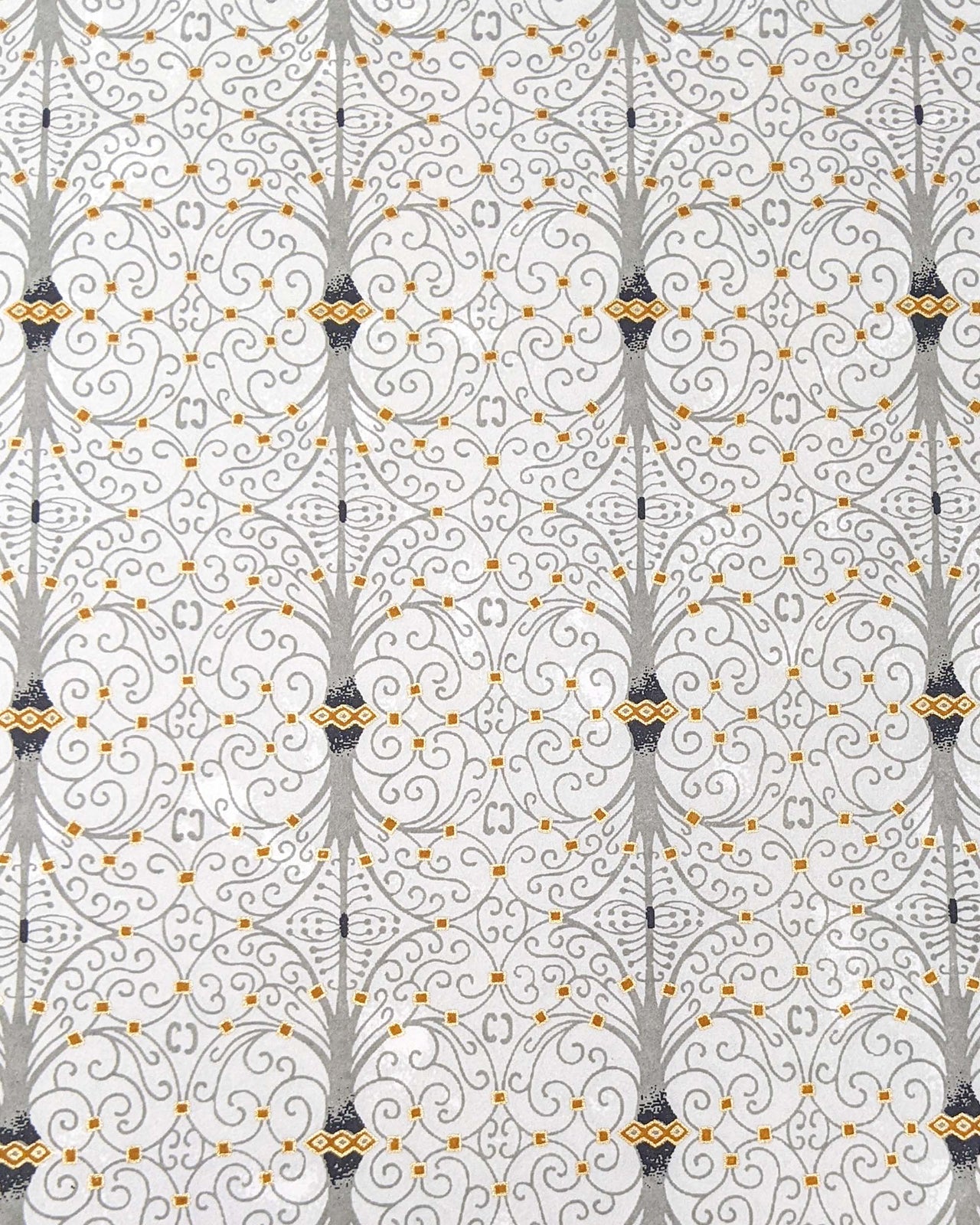 Japanese chiyogami paper featuring a gray wrought iron design on a light gray background with metallic gold details.