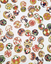 Japanese chiyogami paper featuring an assortment of colorful Japanese temari balls on a white background with metallic gold details.