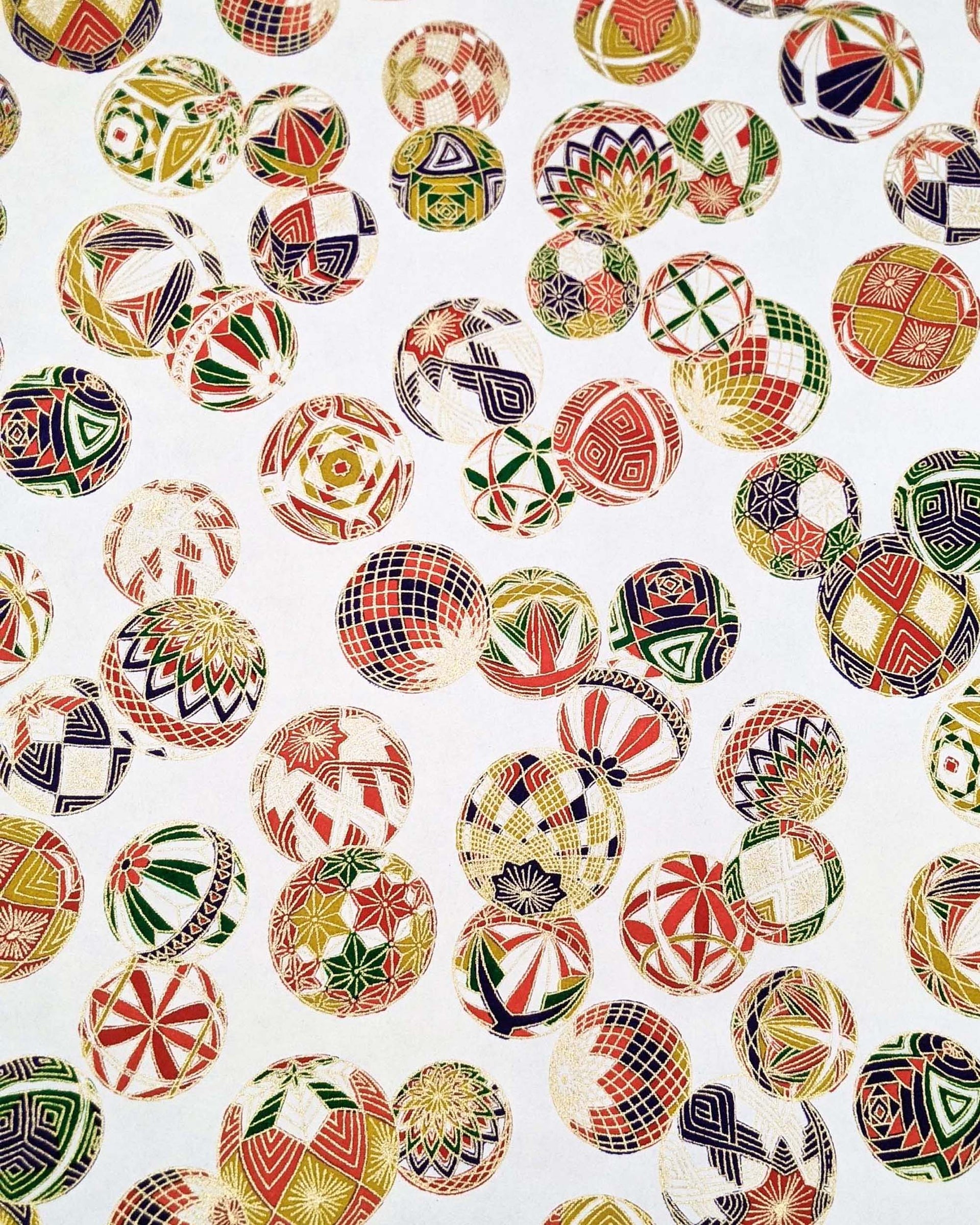 Japanese chiyogami paper featuring an assortment of colorful Japanese temari balls on a white background with metallic gold details.