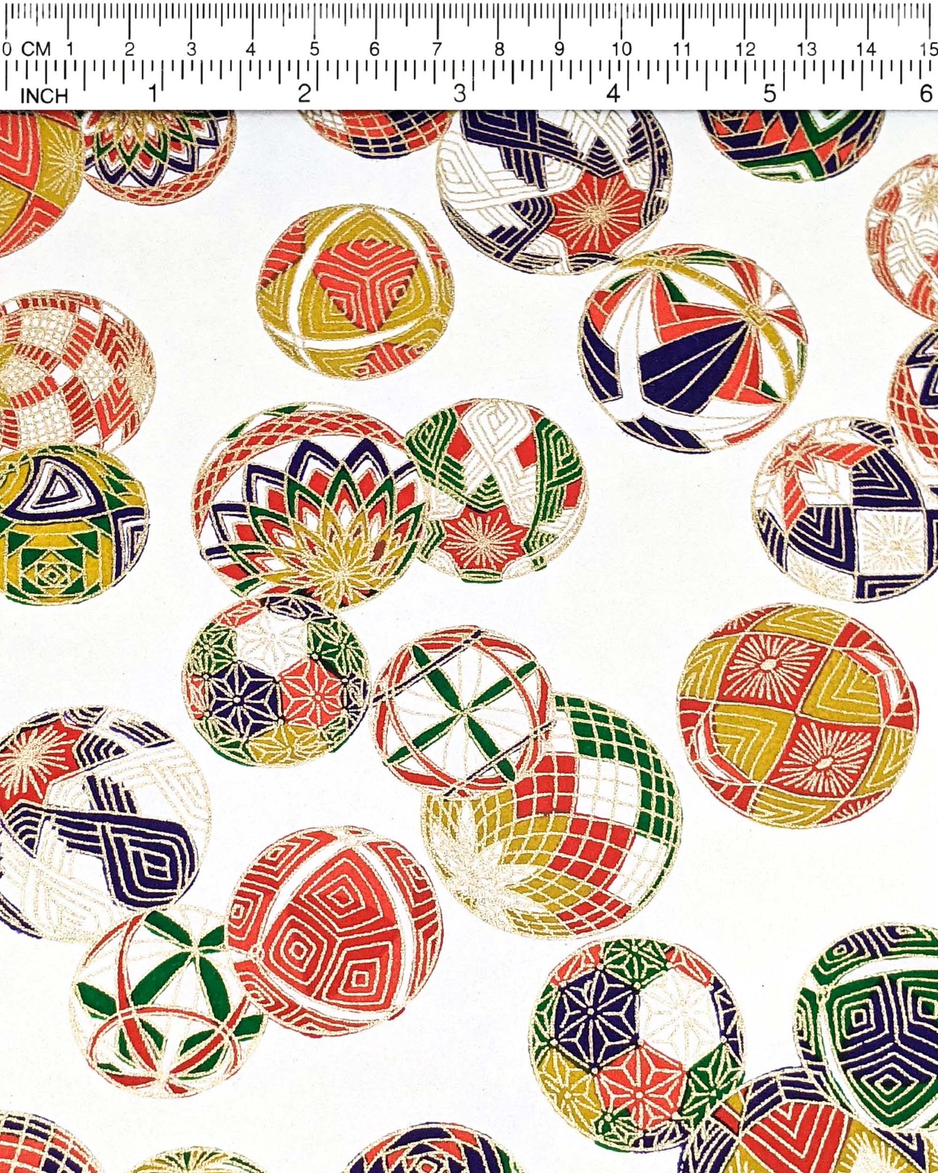 Japanese chiyogami paper featuring an assortment of colorful Japanese temari balls on a white background with metallic gold details.