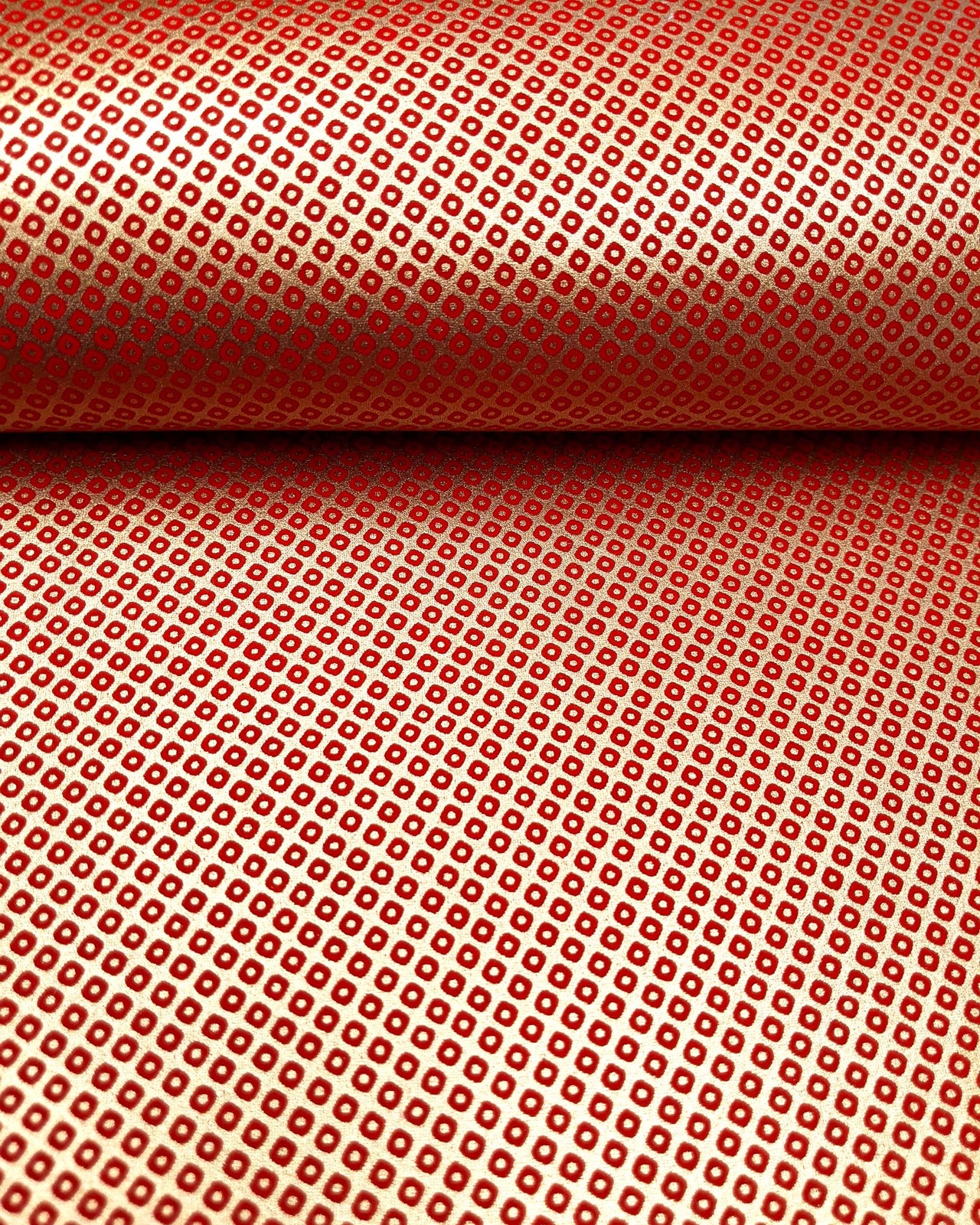 Japanese chiyogami paper featuring a traditional metallic gold and red kanoko design. 