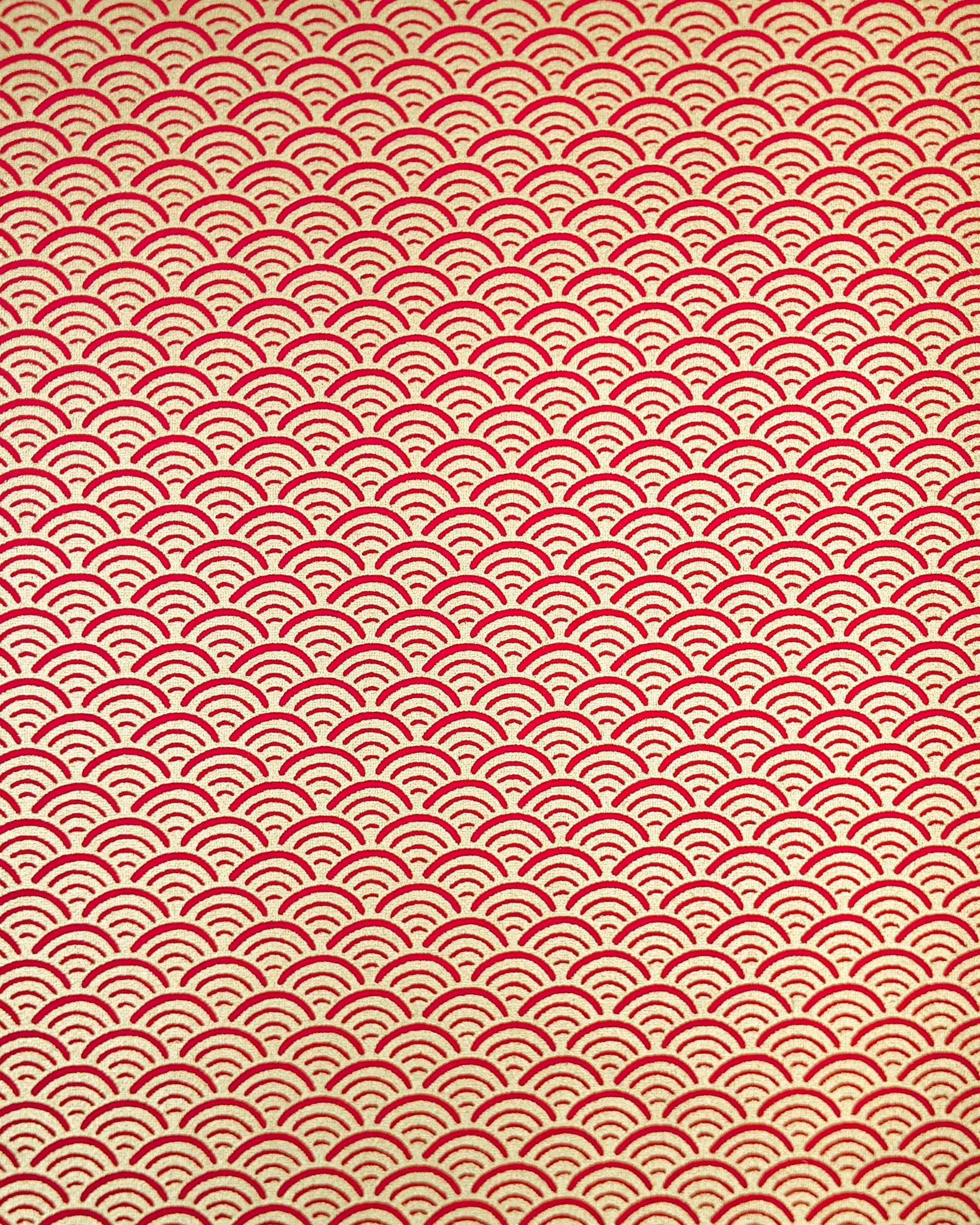 Japanese chiyogami paper featuring a traditional red and metallic gold seigaiha (wave crests) pattern.