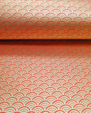 Japanese chiyogami paper featuring a traditional red and metallic gold seigaiha (wave crests) pattern.