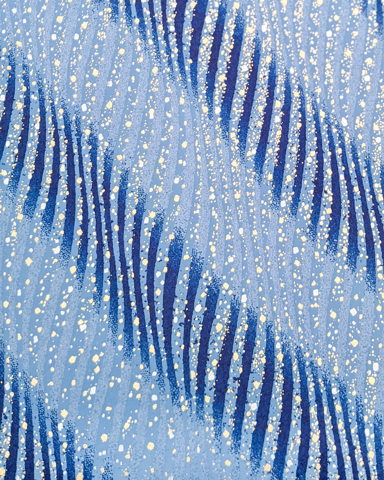 Japanese chiyogami paper featuring blue swirls with metallic gold and silver details.