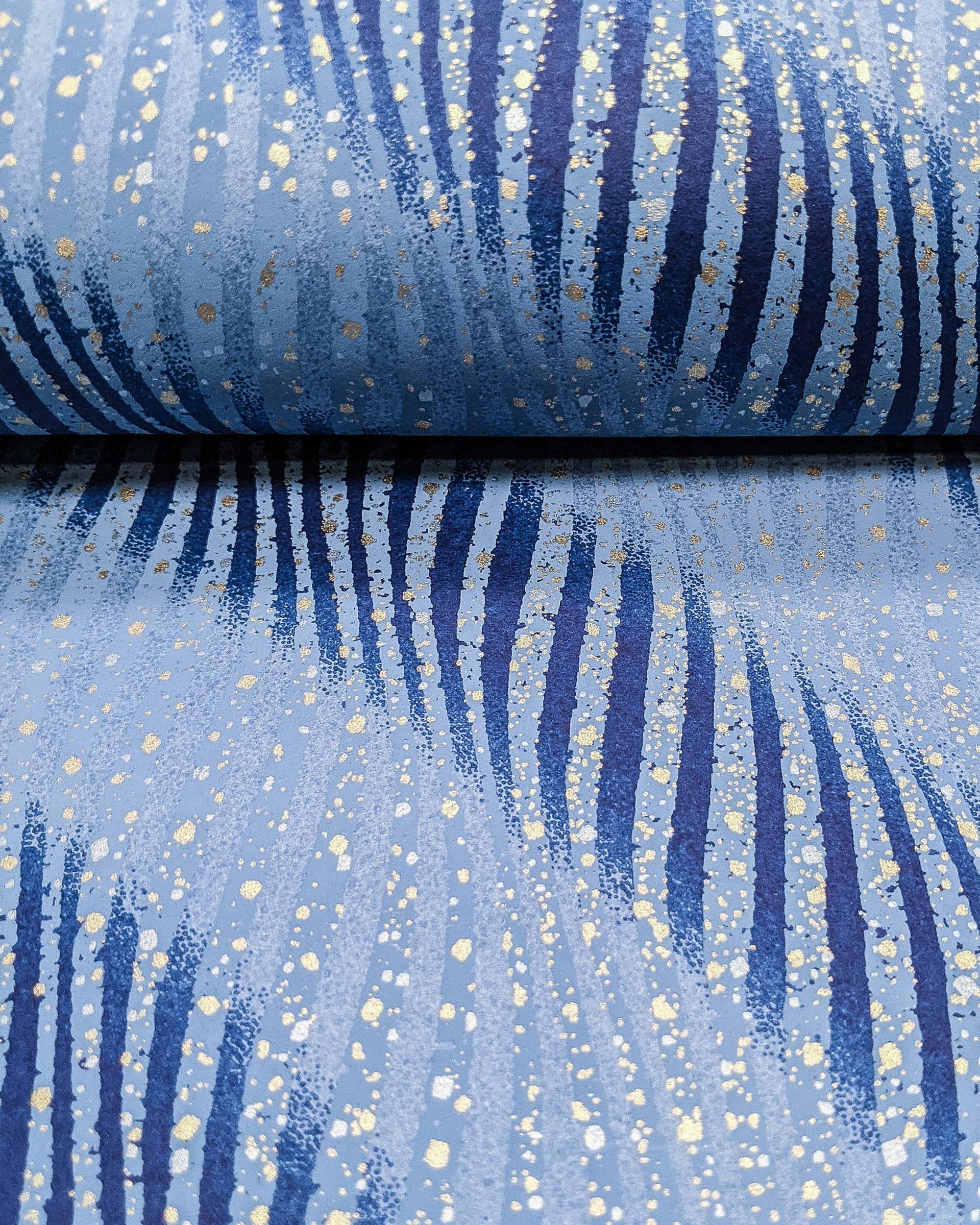 Japanese chiyogami paper featuring blue swirls with metallic gold and silver details.