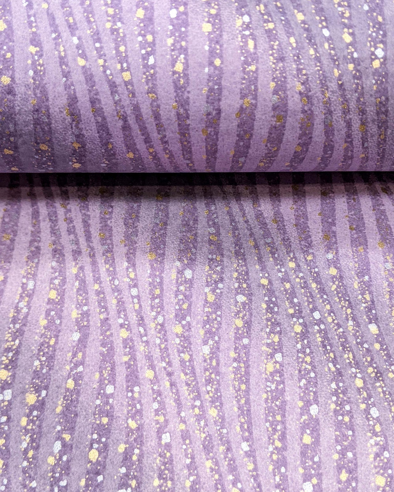 Japanese chiyogami paper featuring purple swirls with metallic gold and silver details.